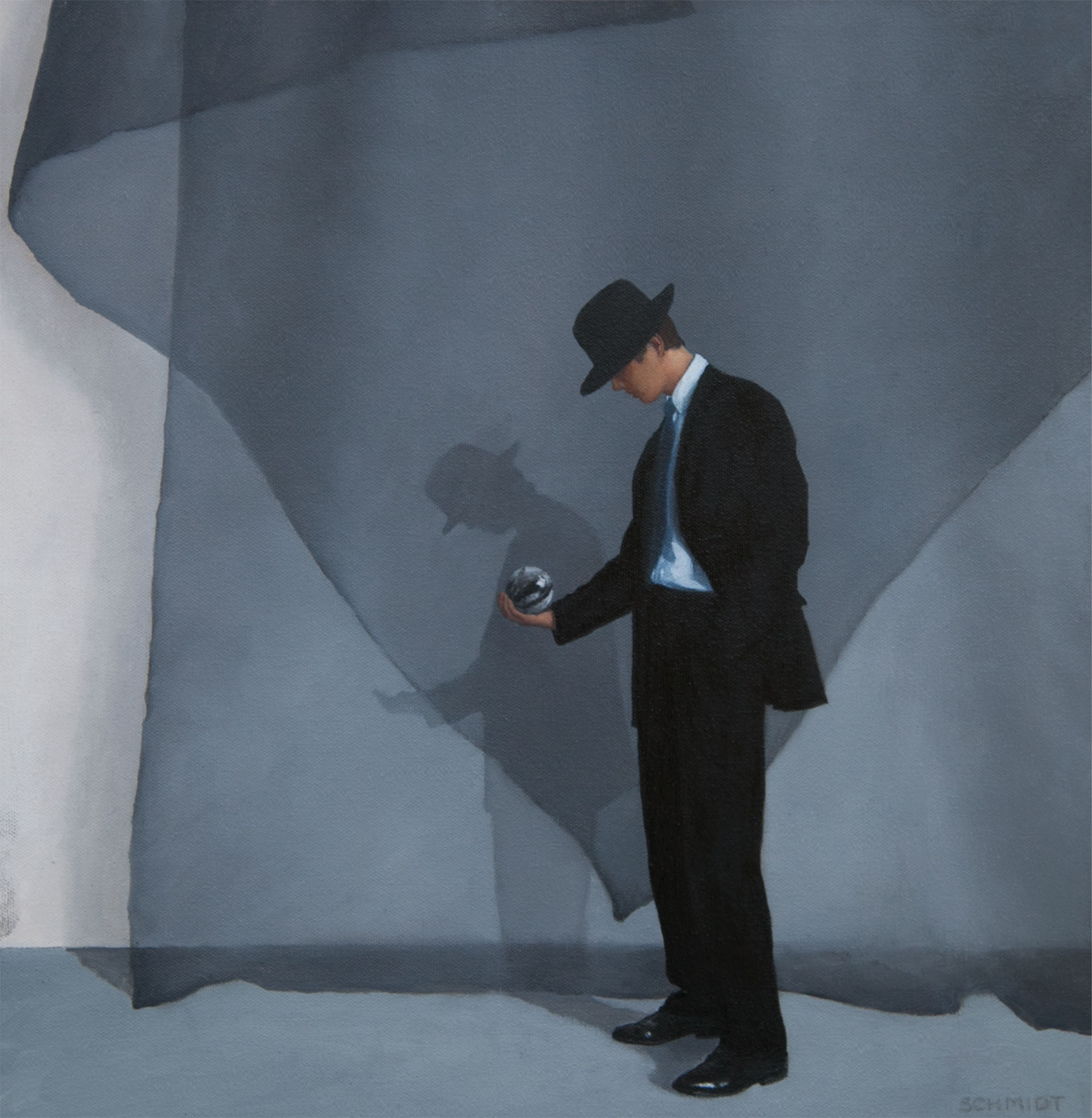 Man in fedora hat and suit looking at a marble