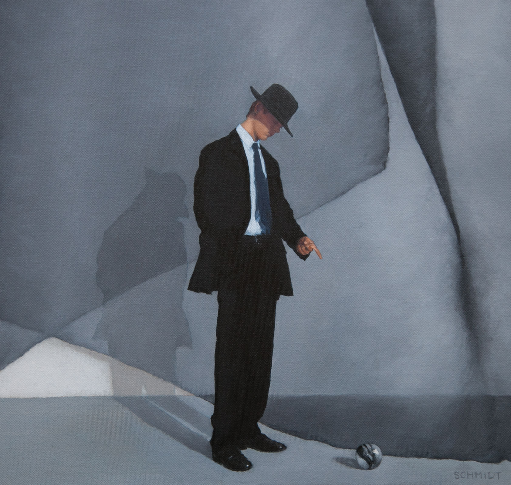 Man standing and pointing to a marble dressed in a fedora hat and suit